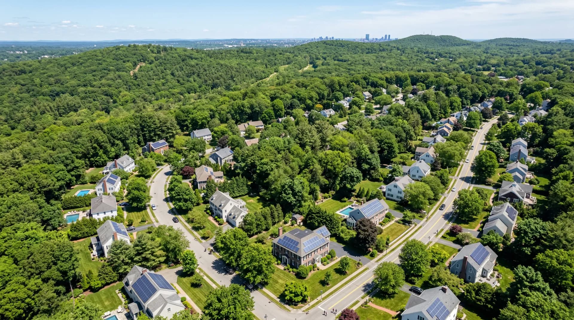 Aerial view of Milton Massachusetts with solar panels on residential rooftops